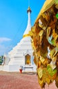 The golden prayer leaves in front of white stupa of Wat Phrathat Doi Kong Mu, Mae Hong Son, Thailand