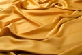 Beautiful golden drapes of cloth. Delicate yellow silk folds texture Royalty Free Stock Photo