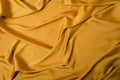 Top view of shiny golden silk, background.Drapes of soft silk Royalty Free Stock Photo