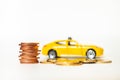 Closeup golden stack coins with yellow car background Royalty Free Stock Photo