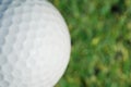 Closeup on a golf ball on green grass Royalty Free Stock Photo