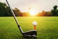 closeup golf club and golf ball on green grass wiht sunset Royalty Free Stock Photo
