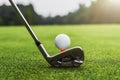 closeup golf club and golf ball on green grass wiht sunset Royalty Free Stock Photo