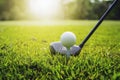 closeup golf club and golf ball on green grass wiht sunset Royalty Free Stock Photo