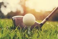 closeup golf club and golf ball on green grass wiht sunset Royalty Free Stock Photo