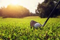 closeup golf club and golf ball on green grass wiht sunset Royalty Free Stock Photo