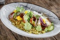 Closeup on gourmet bowl of unagi eel and couscous