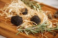 Closeup on gourmet truffles mushrooms with rosemar