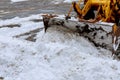 Closeup of grader cleaning snow covered road after blizzard Royalty Free Stock Photo