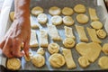 Closeup of a grandmothers hands preparing bisquits in the kitchen. Horizontal view.