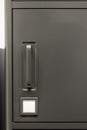 Closeup of gray metal cabinet with handle and label. Office minimal. Royalty Free Stock Photo