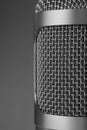 Closeup of a gray microphone on gray background