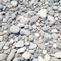 Closeup gray pebbles scattered on a peaceful beach