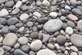 Closeup gray pebbles scattered on a peaceful beach