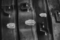 Closeup grayscale shot of vintage banjo and guitar cases.