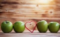 Closeup green apple stack in a row and red heart