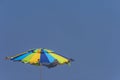 Green, Blue and Yellow Beach Umbrella Against Blue Sky Royalty Free Stock Photo