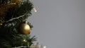 Gold, White and Silver Christmas Ornaments in Christmas Tree Branch Royalty Free Stock Photo