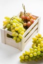 Closeup of green grapes in a wooden box on white background Royalty Free Stock Photo