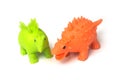 green and orange color plastic dinosaurs toys on white background Royalty Free Stock Photo