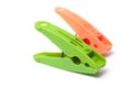 Green and orange plastic clothespins on white backgro Royalty Free Stock Photo