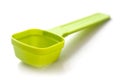 Green plastic dose spoon on white background Royalty Free Stock Photo