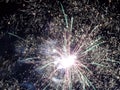 Closeup of green, red and yellow fireworks against a night sky, new year, party