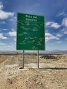 Closeup of a green sign in the deserttranslation: desert route