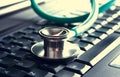 Green stethoscope lying on a blue notebook keyboard (selective focus)