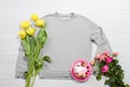 Closeup grey blank template sweatshirt hoodie copy space. Mothers women day yellow tulips, pink roses, cake. Happy birthday top Royalty Free Stock Photo