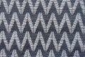 Close view of grey fabric with white zigzags