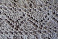 Closeup of grey handmade knitted fabric with zigzag pattern