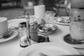 Closeup greyscale shot of salt and pepper on a table