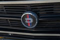 Closeup of grill emblem of a beautiful shiny Nissan Datsun 1200 car