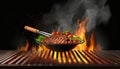 Closeup Of Grill With Fire And Charcoal. Hot empty barbecue BBQ grill with flaming fire and ember charcoal on black background