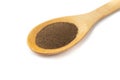 Closeup of ground black pepper on a wooden spoon isolated over white background Royalty Free Stock Photo