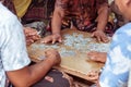 Closeup of group of balinese men playing cards on the floor. Bali island, Indonesia.