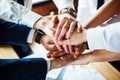 Closeup of a group of businesspeople joining their hands together. Royalty Free Stock Photo