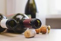 Closeup of a group of champagne corks on the table with Empty wine bottle