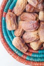 Closeup of Group of dried dates in wicker bowl