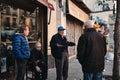 Closeup of a group of elderly men talking outside a bar in Madrid