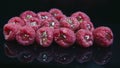 Closeup group of fresh raspberries staffed with jelly lie on black background