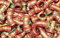 Closeup of group many different press contour bends for copper round pipes used for plumbing and heating installation