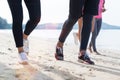Closeup Of Group Of People Running On Beach Feet Shot Sport Runners Jogging Working Out Team Men And Women Fitness Royalty Free Stock Photo