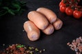 closeup group of thick short sausages with dill and tomatoes Royalty Free Stock Photo