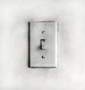 Closeup of a grungy dirty old white light switch on a wall Royalty Free Stock Photo