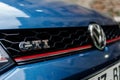 Closeup of GTI VW Volkswagen logo on a blue car