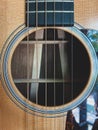 Closeup guitar stings with sound hole acoustic guitar.