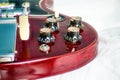 Closeup of guitar tone and volume witch hat knobs with maestro vibrato 1966 on cherry color Gibson SG solid guitar standard,