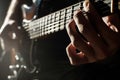 closeup of guitarist fingers on fretboard, spotlight on hands